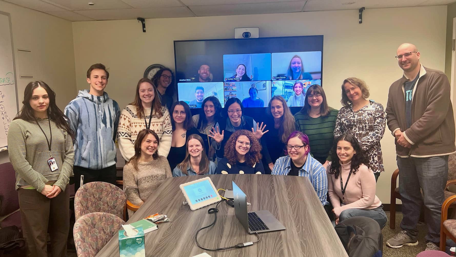 SHARP lab members smiling in a meeting room